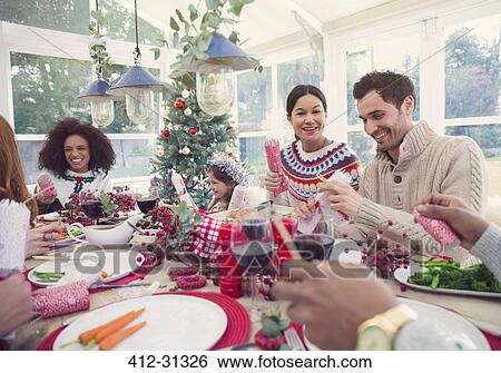 Family enjoying Christmas dinner View Large Photo Image Stock Photograph - Family enjoying Christmas dinner. Fotosearch
