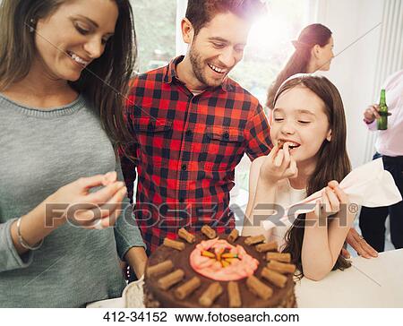 Family icing and decorating chocolate cake View Large Photo Image Stock Image - Family icing and decorating chocolate cake. Fotosearch