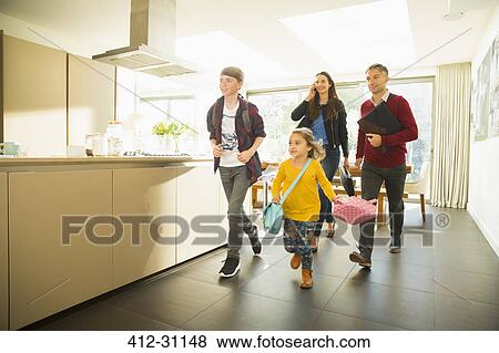Stock Photo - Family rushing out of the house in the morning. Fotosearch