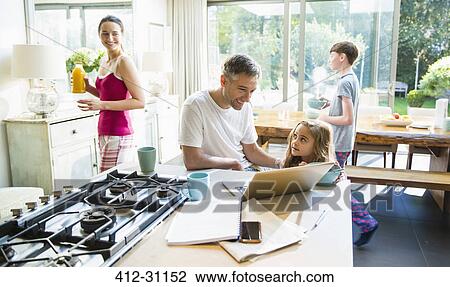 Family with breakfast and laptop in morning kitchen View Large Photo Image Stock Image - Family with breakfast and laptop in morning kitchen. Fotosearch