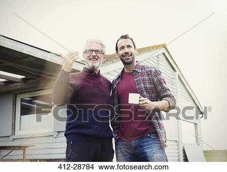 Father and son talking and drinking coffee outside house View Large Photo Image Picture - Father and son talking and drinking coffee outside house. Fotosearch