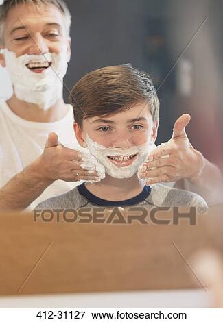Father helping son pretending to shave in bathroom mirror View Large Photo Image Stock Photo - Father helping son pretending to shave in bathroom mirror. Fotosearch
