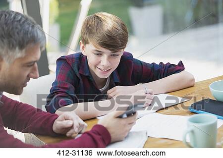 Father with calculator helping son with math homework View Large Photo Image Stock Photograph - Father with calculator helping son with math homework. Fotosearch