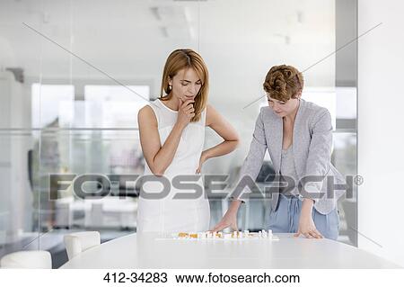 Female architects examining model in conference room View Large Photo Image Stock Image - Female architects examining model in conference room. Fotosearch