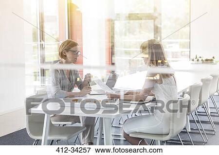 Female architects meeting in conference room View Large Photo Image Stock Photo - Female architects meeting in conference room. Fotosearch