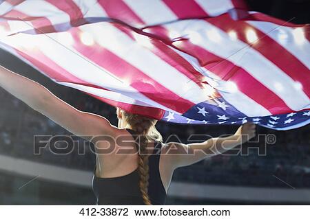 Female athlete running victory lap with American flag View Large Photo Image Stock Image - Female athlete running victory lap with American flag. Fotosearch