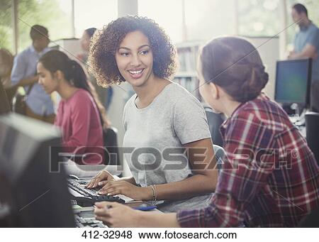 Female college students using computers in computer lab library View Large Photo Image Stock Photo - Female college students using computers in computer lab library. Fotosearch