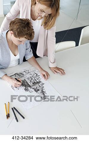 Picture - Female designers drawing sketch in conference room. Fotosearch