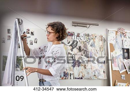 Female fashion designer brainstorming at flipchart View Large Photo Image Stock Photo - Female fashion designer brainstorming at flipchart. Fotosearch
