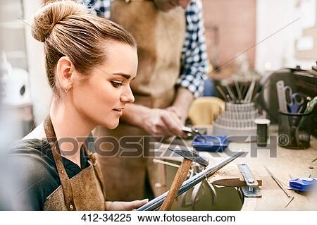 Female jeweler using equipment in workshop View Large Photo Image Stock Photography - Female jeweler using equipment in workshop. Fotosearch