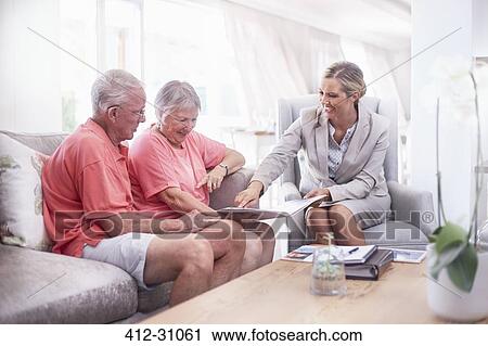Financial advisor discussing paperwork with senior couple View Large Photo Image Stock Image - Financial advisor discussing paperwork with senior couple. Fotosearch