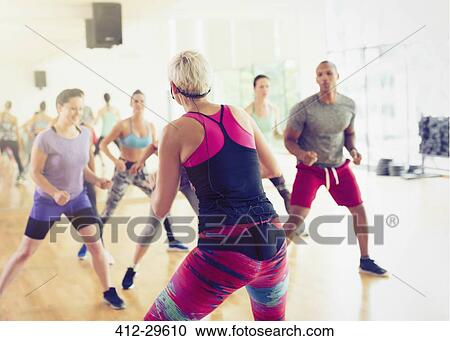 Fitness instructor leading aerobics class View Large Photo Image Stock Image - Fitness instructor leading aerobics class. Fotosearch