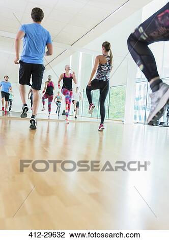 Fitness instructor leading aerobics class View Large Photo Image Stock Image - Fitness instructor leading aerobics class. Fotosearch