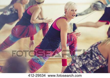 Fitness instructor leading class in lunge View Large Photo Image Picture - Fitness instructor leading class in lunge. Fotosearch