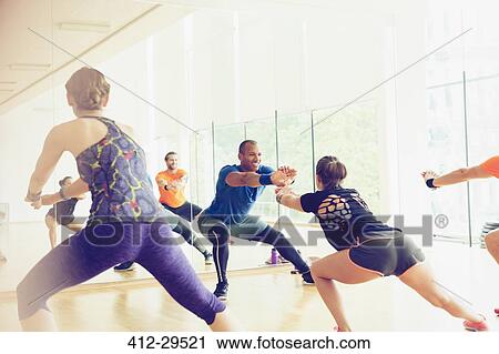 Fitness instructor leading exercise class View Large Photo Image Stock Image - Fitness instructor leading exercise class. Fotosearch
