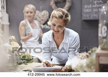 Florist using digital tablet in flower shop View Large Photo Image Stock Photography - Florist using digital tablet in flower shop. Fotosearch