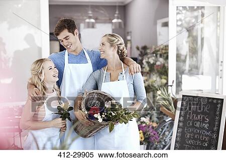 Florists smiling and hugging in flower shop View Large Photo Image Stock Photography - Florists smiling and hugging in flower shop. Fotosearch