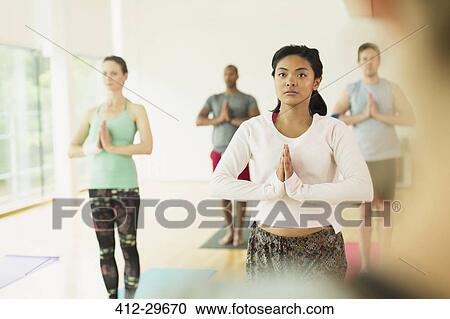 Focused woman with hands at prayer position in yoga class View Large Photo Image Stock Image - Focused woman with hands at prayer position in yoga class. Fotosearch