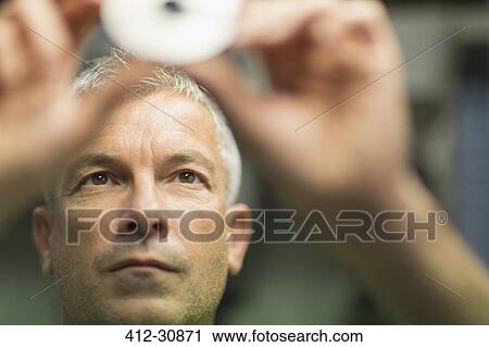 Focused worker examining part in steel factory View Large Photo Image Stock Image - Focused worker examining part in steel factory. Fotosearch