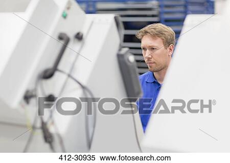 Stock Photography - Focused worker in steel factory. Fotosearch