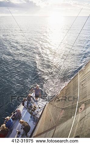 Friends sailing on sailboat on sunny ocean View Large Photo Image Stock Photography - Friends sailing on sailboat on sunny ocean. Fotosearch