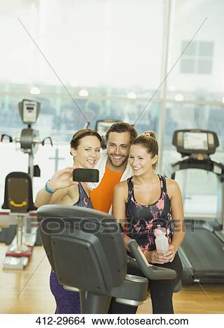 Friends taking selfie at gym View Large Photo Image Picture - Friends taking selfie at gym. Fotosearch