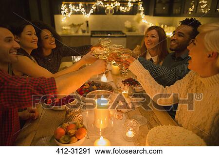 Friends toasting champagne glasses at candlelight table View Large Photo Image Stock Image - Friends toasting champagne glasses at candlelight table. Fotosearch
