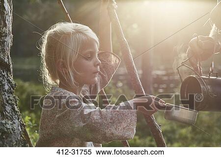 Stock Photography - Girl receiving hot soup in sunny woods. Fotosearch