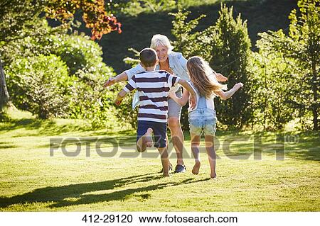 Grandchildren running to grandmother in sunny garden View Large Photo Image Stock Image - Grandchildren running to grandmother in sunny garden. Fotosearch