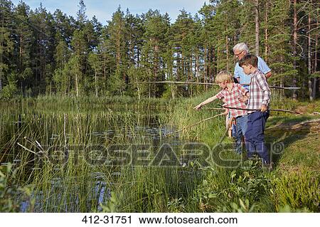 Grandfather teaching grandsons fishing at sunny lakeside View Large Photo Image Stock Image - Grandfather teaching grandsons fishing at sunny lakeside. Fotosearch