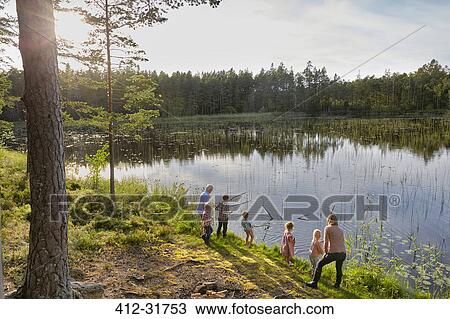 Grandparents and grandchildren fishing at sunny lakeside in woods View Large Photo Image Stock Image - Grandparents and grandchildren fishing at sunny lakeside in woods. Fotosearch