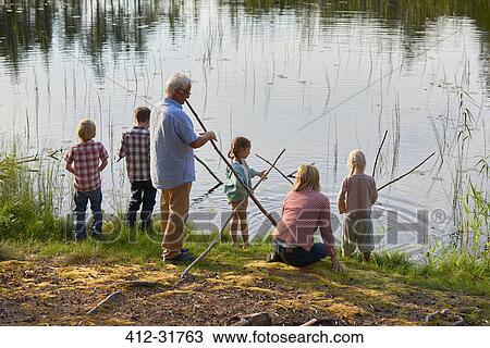 Grandparents and grandchildren fishing at lakeside View Large Photo Image Stock Image - Grandparents and grandchildren fishing at lakeside. Fotosearch
