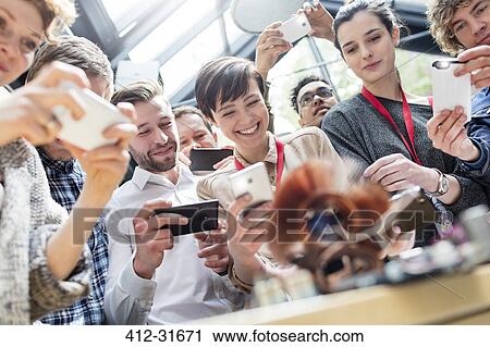 Group with camera phones at technology conference View Large Photo Image Stock Image - Group with camera phones at technology conference. Fotosearch