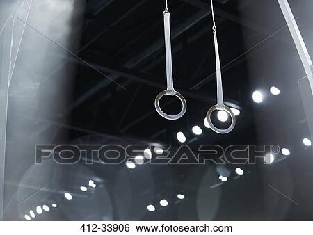 Gymnastics rings hanging in arena View Large Photo Image Stock Photograph - Gymnastics rings hanging in arena. Fotosearch