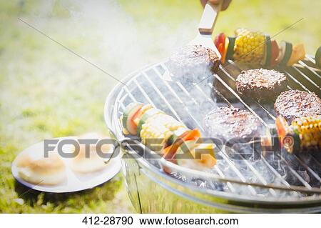 Hamburgers and vegetable skewers on barbecue grill View Large Photo Image Stock Image - Hamburgers and vegetable skewers on barbecue grill. Fotosearch