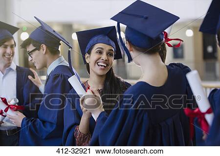 Happy female college student graduates with cap and gown and diplomas celebrating View Large Photo Image Stock Image - Happy female college student graduates with cap and gown and diplomas celebrating. Fotosearch