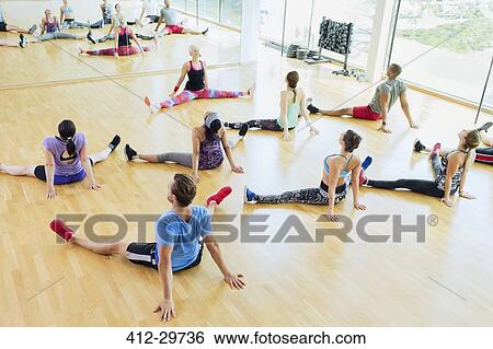High angle view exercise class stretching with legs apart at gym View Large Photo Image Stock Photograph - High angle view exercise class stretching with legs apart at gym. Fotosearch