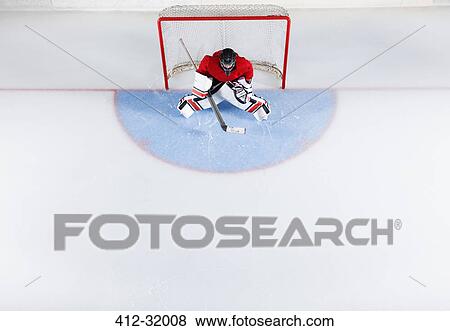 Hockey goalie in red uniform protecting goal net View Large Photo Image Stock Photo - Hockey goalie in red uniform protecting goal net. Fotosearch
