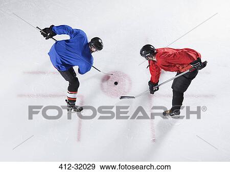 Stock Photo - Hockey opponents in opening face off. Fotosearch