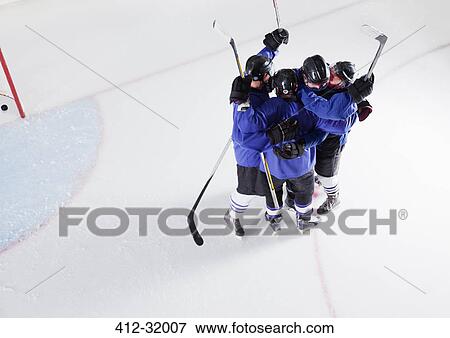Hockey team in blue uniforms cheering celebrating on ice View Large Photo Image Stock Photo - Hockey team in blue uniforms cheering celebrating on ice. Fotosearch