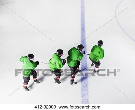 Hockey team in green uniforms skating in a row on ice View Large Photo Image Stock Photo - Hockey team in green uniforms skating in a row on ice. Fotosearch