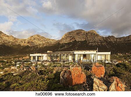 Stock Photograph - Home showcase exterior among craggy landscape. Fotosearch