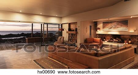 Home showcase interior living room overlooking ocean at sunset View Large Photo Image Stock Image - Home showcase interior living room overlooking ocean at sunset. Fotosearch