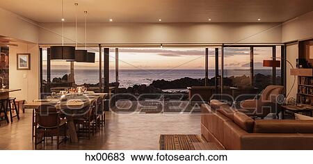Home showcase interior overlooking ocean at sunset View Large Photo Image Stock Image - Home showcase interior overlooking ocean at sunset. Fotosearch