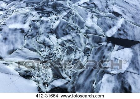 Picture - Ice swirling in ocean. Fotosearch