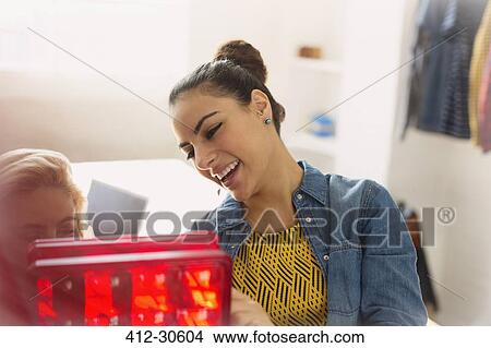 Picture - Innovative young businesswomen examining prototype. Fotosearch