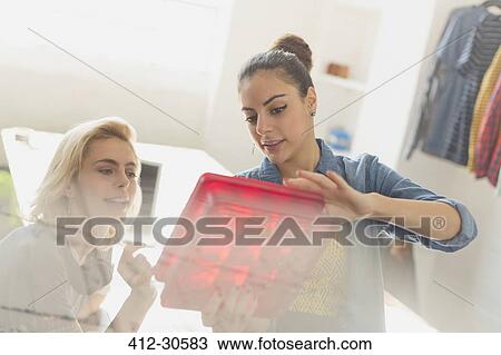 Innovative young businesswomen examining prototype View Large Photo Image Stock Image - Innovative young businesswomen examining prototype. Fotosearch