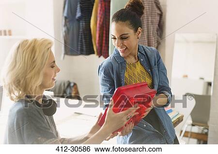 Innovative young businesswomen examining prototype in office View Large Photo Image Stock Photograph - Innovative young businesswomen examining prototype in office. Fotosearch