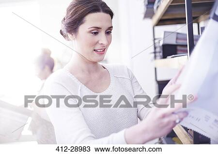 Interior designer browsing fabric swatches View Large Photo Image Stock Image - Interior designer browsing fabric swatches. Fotosearch