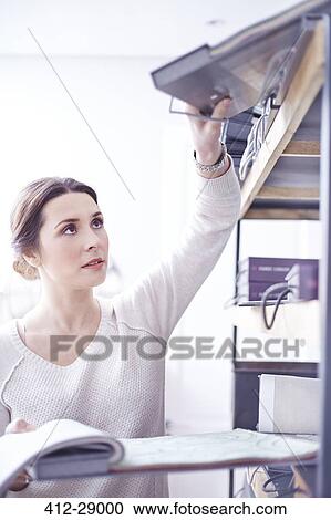 Interior designer reaching for swatch book on shelf View Large Photo Image Stock Image - Interior designer reaching for swatch book on shelf. Fotosearch